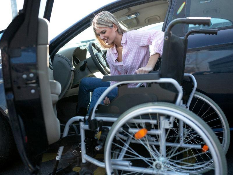 kobieta siadająca na wózek inwalidzki
